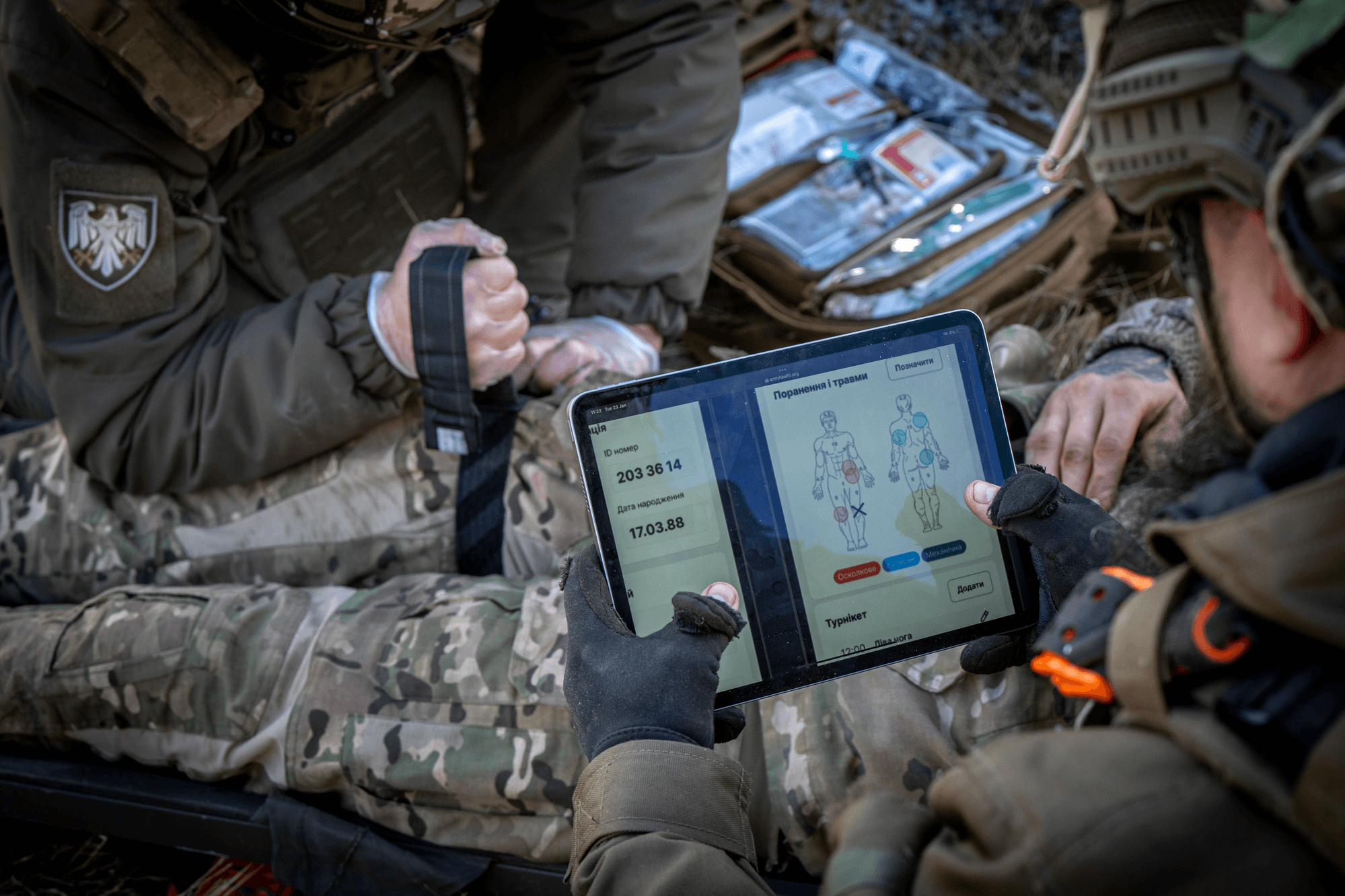 A combat medic recording a casualty on the AHS-UA1 tablet in the field